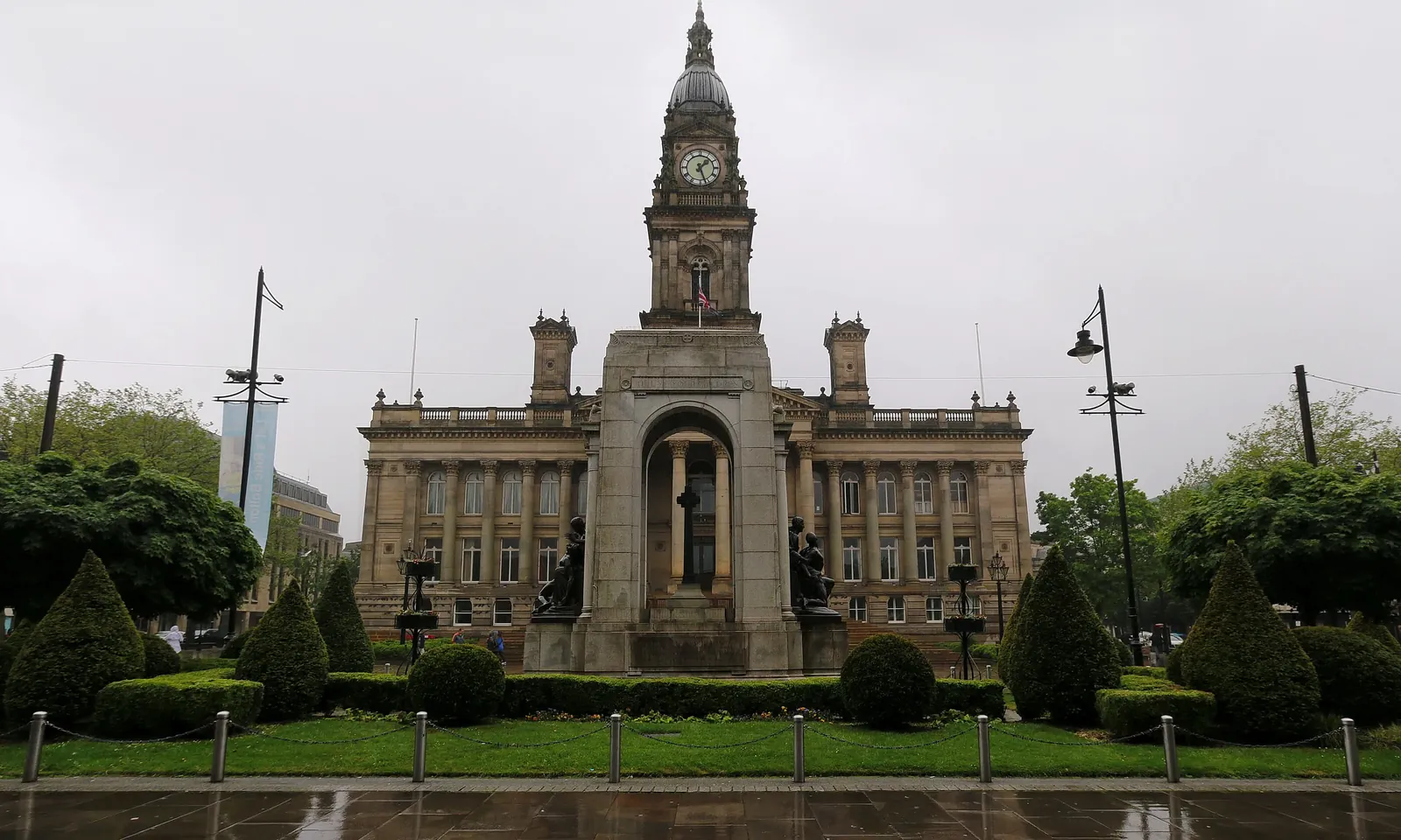 Bolton Town Hall's clock tower rising behind the cenotaph in Victoria Square