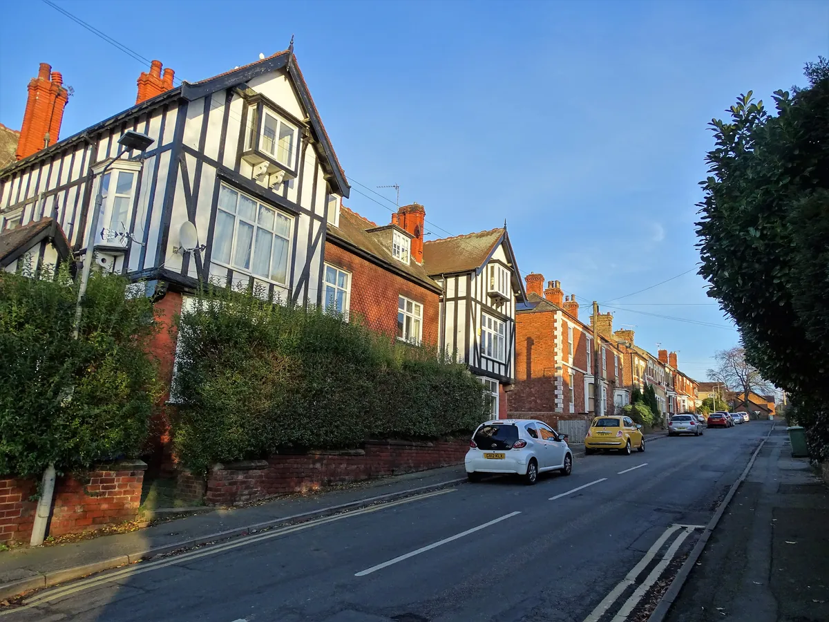 Mock Tudor and red-brick houses behind hedges on Sunnyside in Worksop