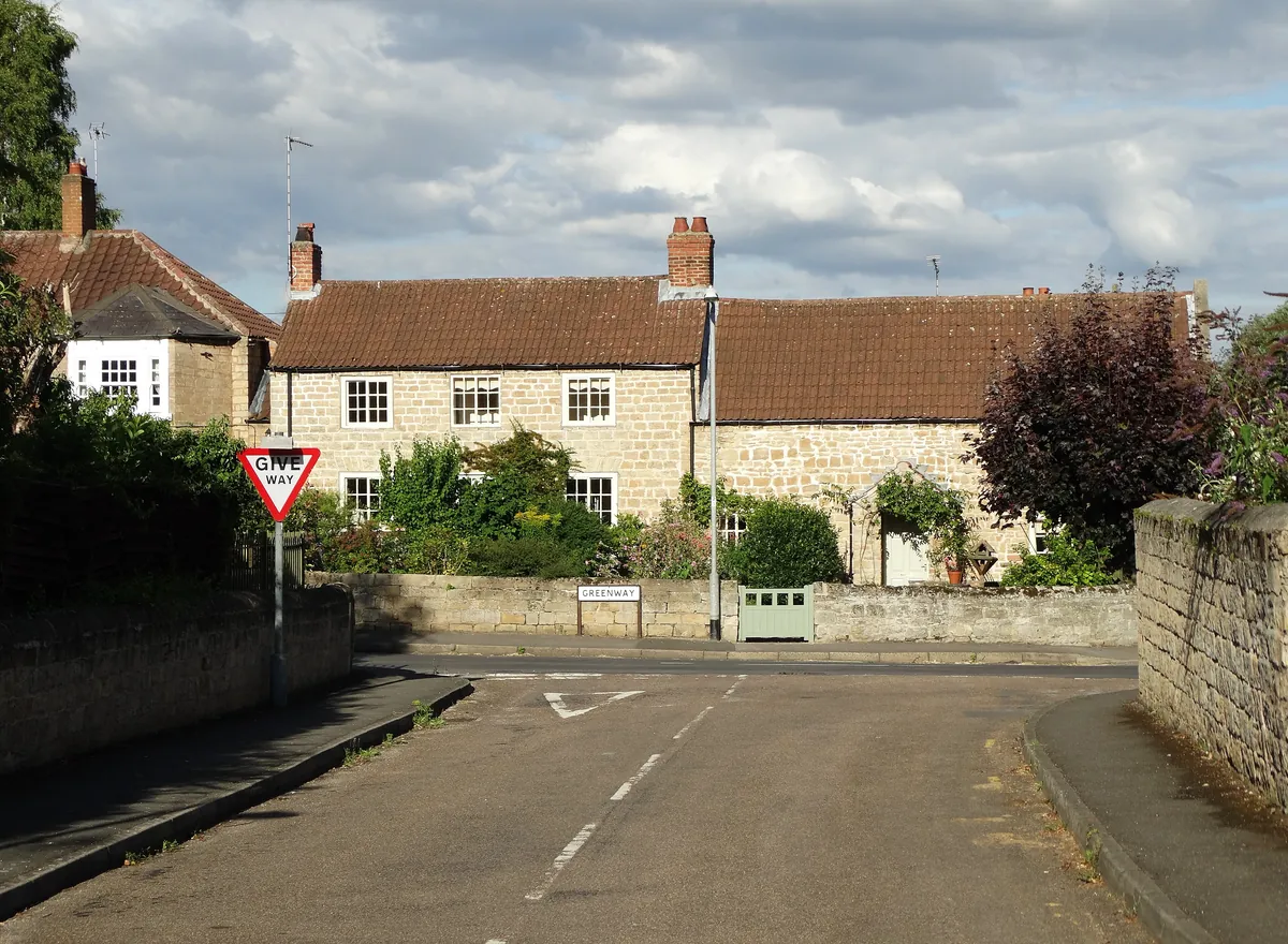 Clover Cottage, a stone cottage with a pantile roof behind a stone wall in Carlton in Lindrick